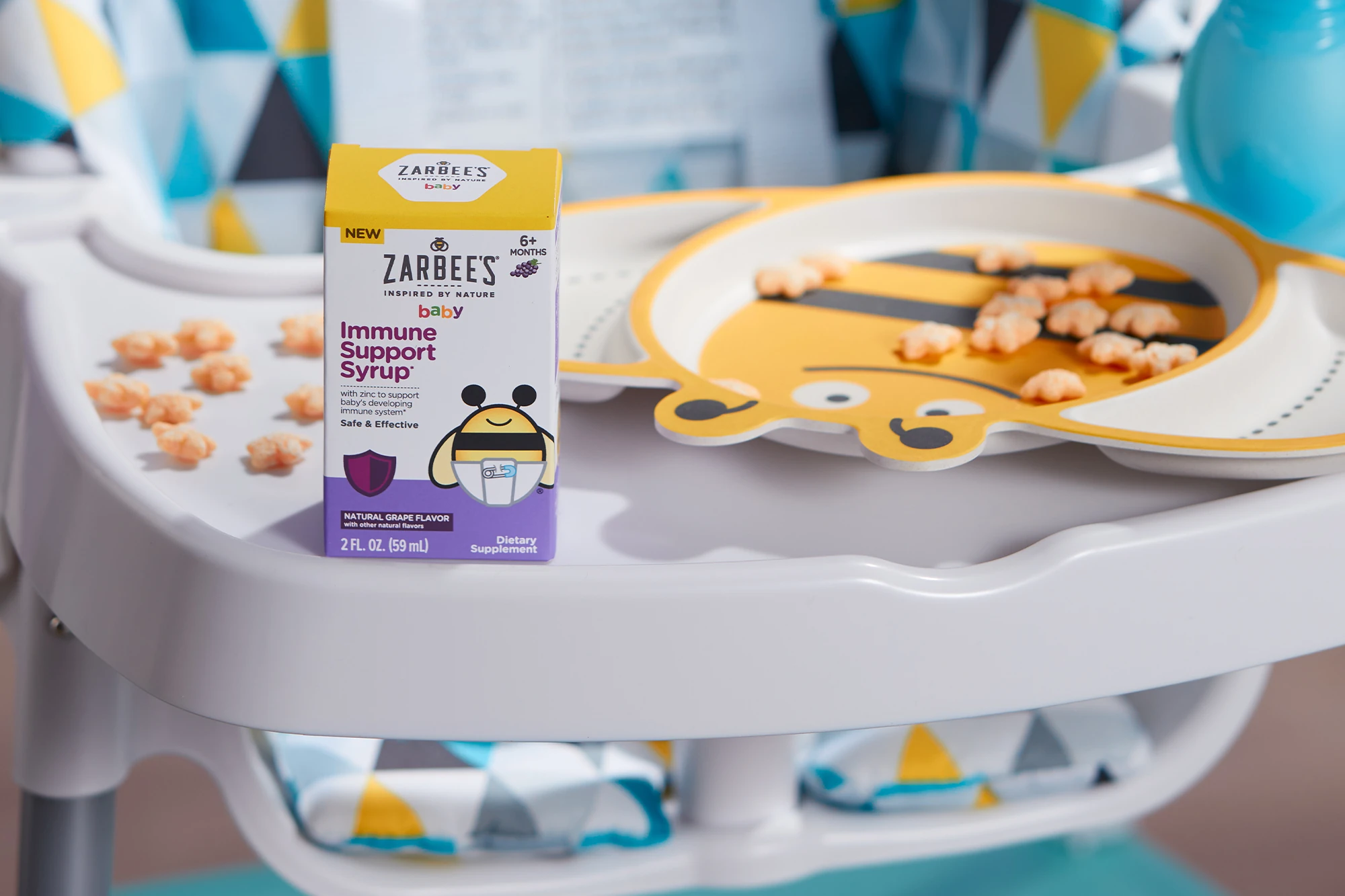 Zarbee's Baby Immune Support Syrup on a Baby Eating Chair